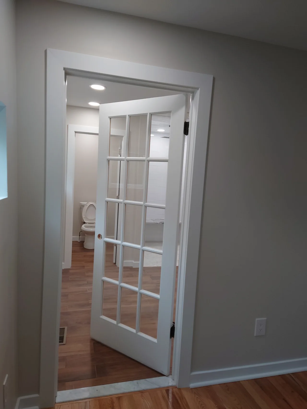 Glass-paneled door and white casing
