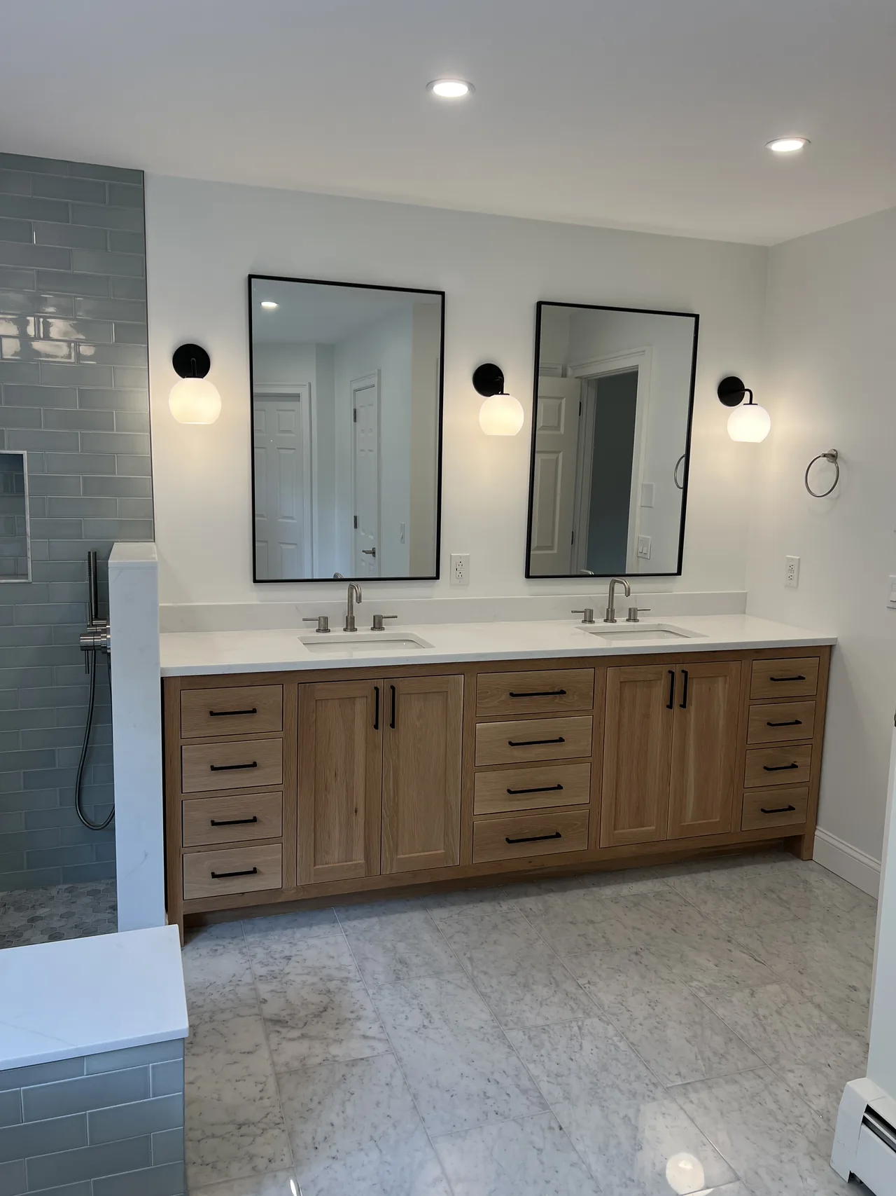 Double wood vanity with twin sinks and wall sconces