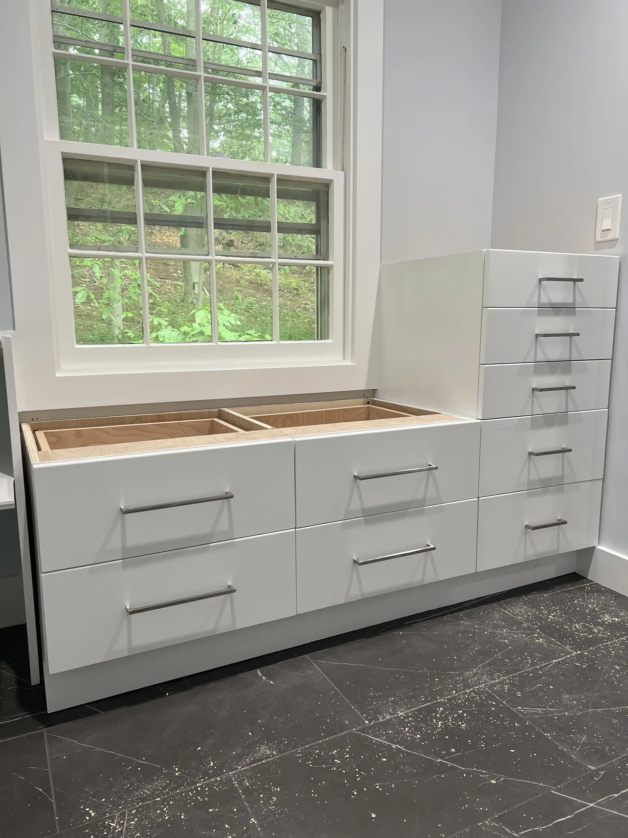 During installation: base cabinets and drawer storage beneath the window