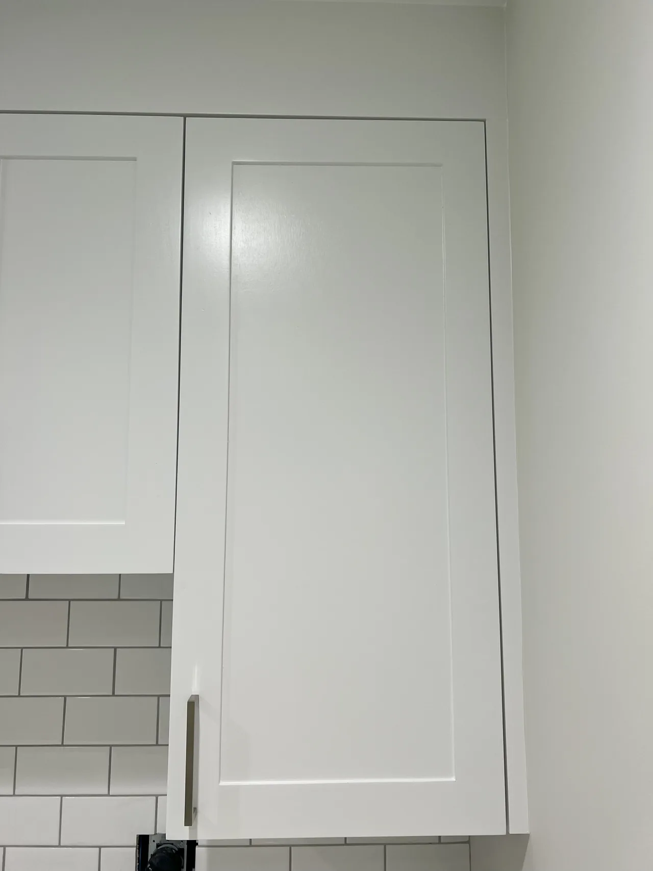 Detail: white cabinet door and metal handle
