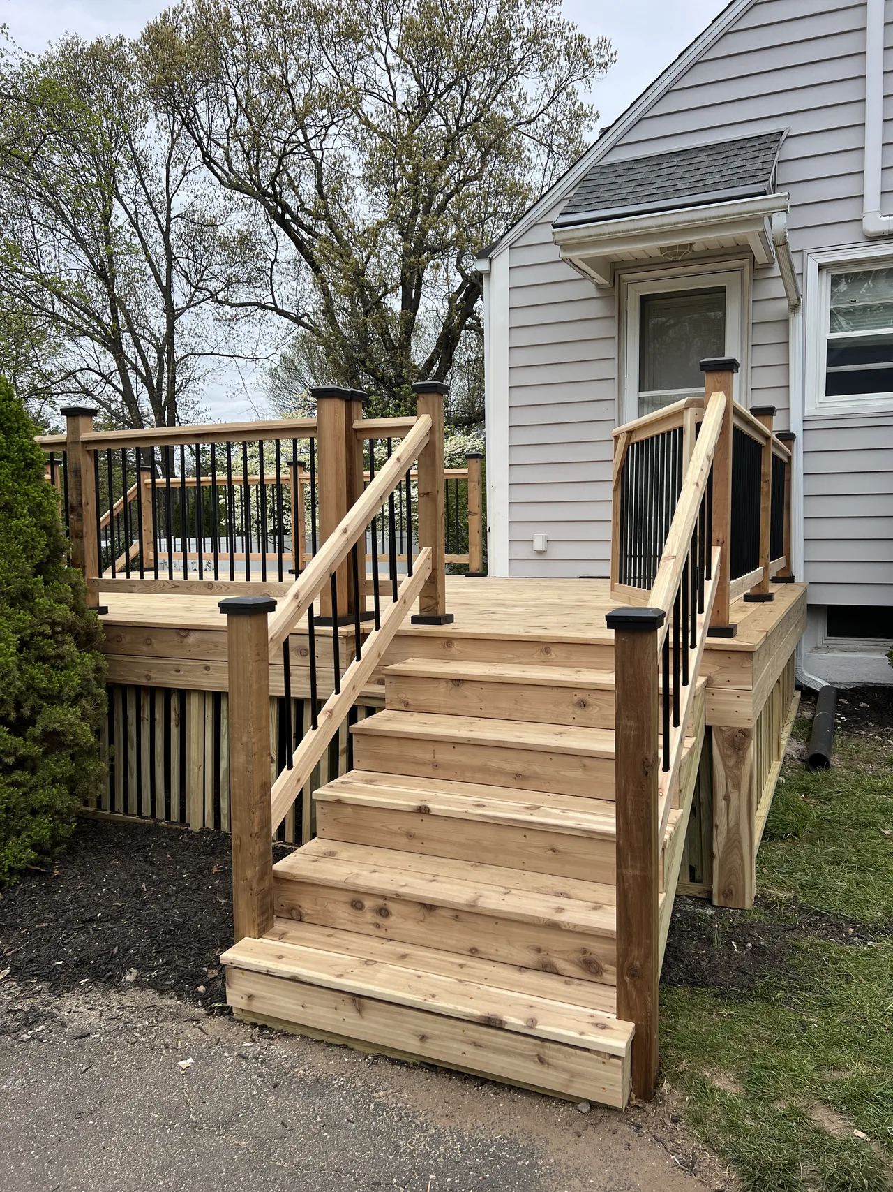 After: wood stairs and dark balusters